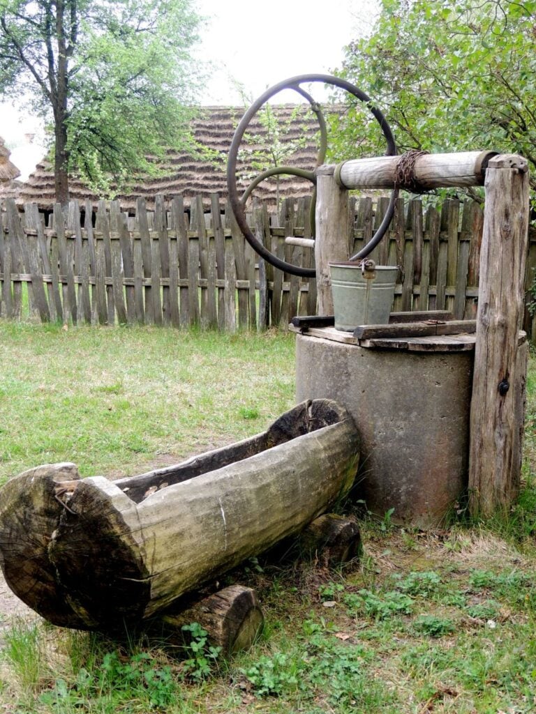 An old wooden well with a bucket